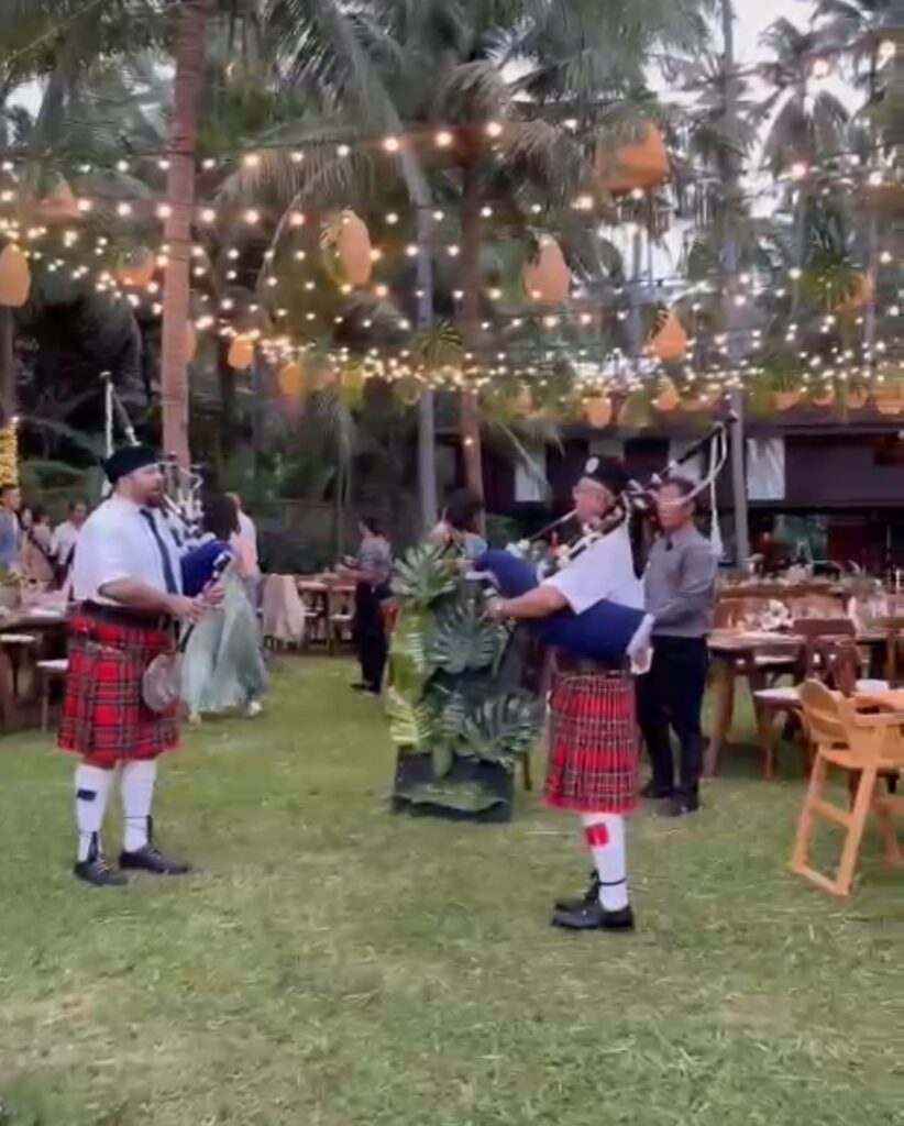 2 bagpipers play to announce dinner at a wedding in Koh Samui.