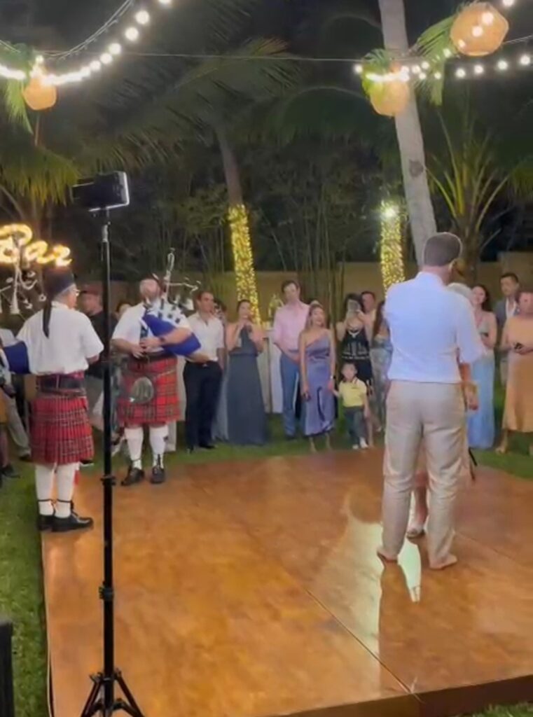 2 bagpipers play on the stage at a wedding to pipe for the groom and mother's dance in Koh Samui.