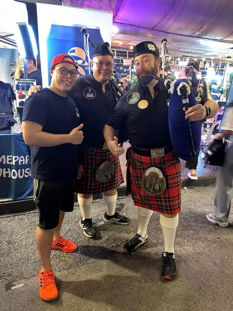 Bagpipers posing with local thai craft brewer in Bangkok Thailand