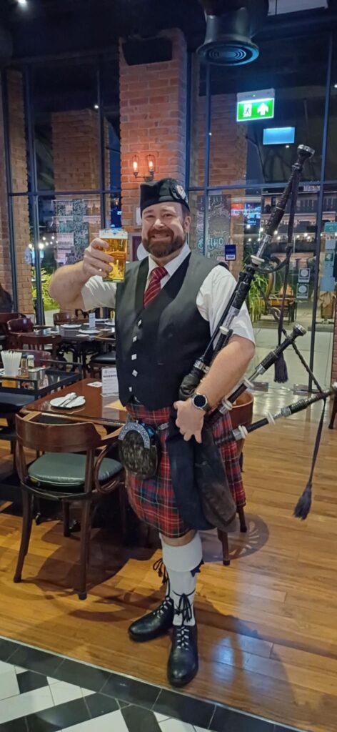 Bagpiper posing with a beer at Londoner Brew Pub in Bangkok Thailand.
Bagpipes in Bangkok