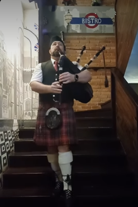 Bagpiper playing and coming down the stairs at Londoner Brew Pub in Bangkok Thailand