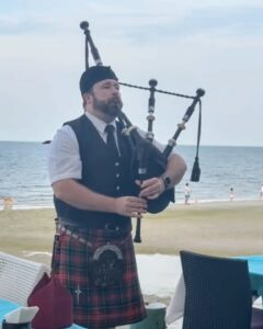 Bagpiper with the beach behind him in Hua Hin