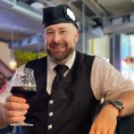 Bagpiper in Bangkok holding a stout